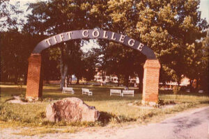 Image of a stone and metal arched entrance to Tift College